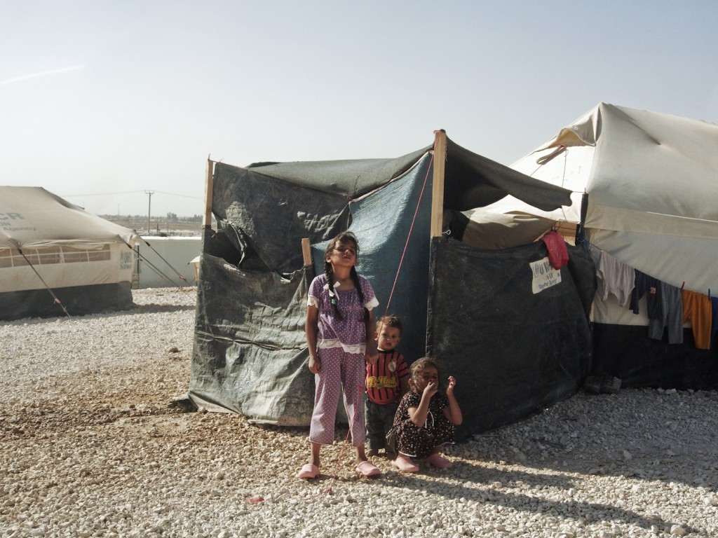 Jordan, June 2013. Syrian children next to their tent in the Zaatari refugee camp. Photo by Moises Saman/MAGNUM