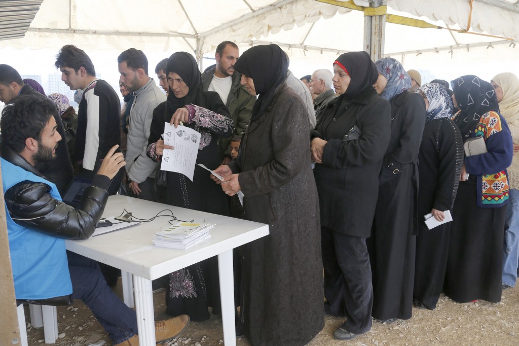Refugees line up at the UNHCR registration center in Tripoli, Lebanon. 